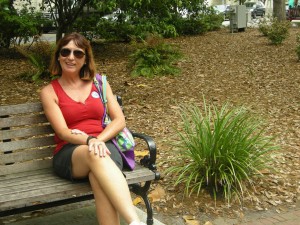 Kathy sitting at a bench in the one Square where Forrest Gump was filmed when he said "Life is like a box of chocolates....."